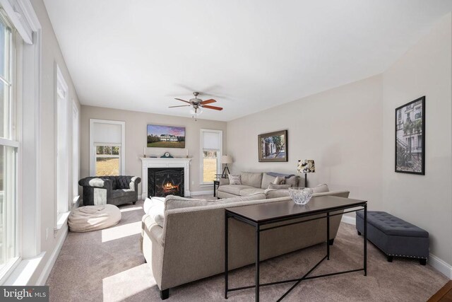 living room featuring light colored carpet and ceiling fan