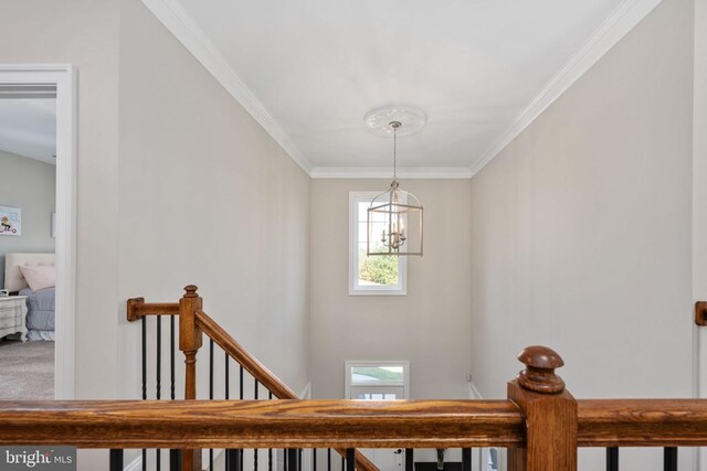 stairs featuring ornamental molding and a chandelier