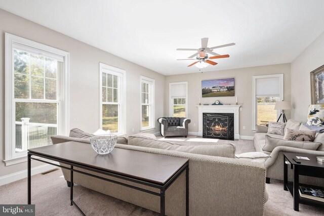 living room with ceiling fan and light colored carpet