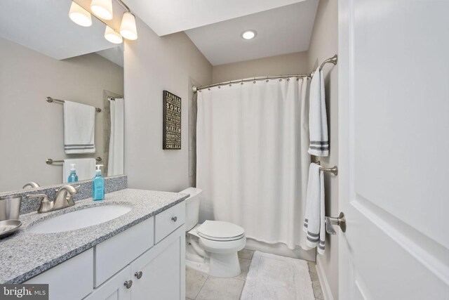 bathroom with tile patterned flooring, vanity, a shower with curtain, and toilet