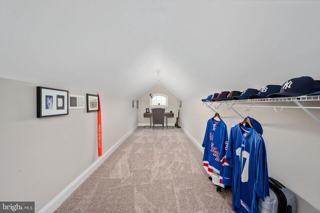 spacious closet with lofted ceiling and carpet floors