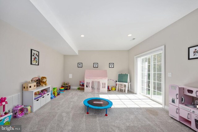 game room with light colored carpet