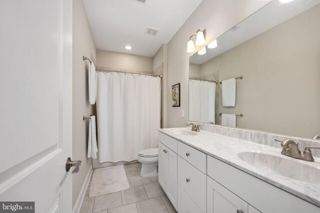 bathroom featuring a shower with curtain, vanity, tile patterned floors, and toilet