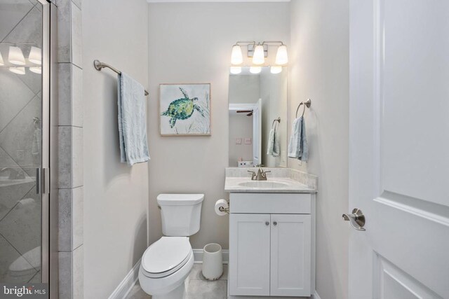 bathroom featuring vanity, toilet, and walk in shower