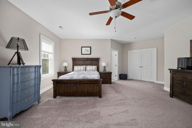 carpeted bedroom with a closet and ceiling fan