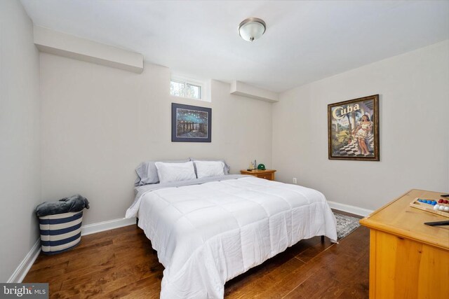 bedroom with dark wood-type flooring