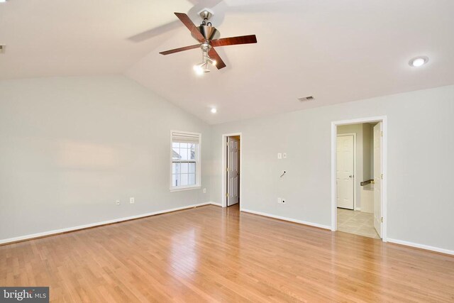 spare room with vaulted ceiling, ceiling fan, and light hardwood / wood-style floors