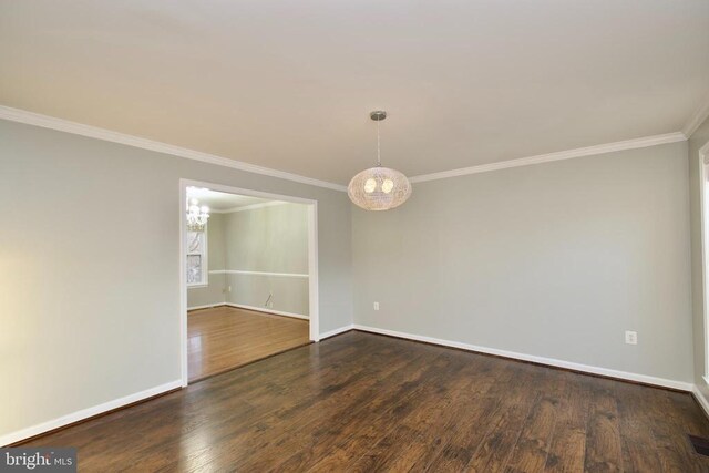 empty room featuring dark wood-type flooring and crown molding