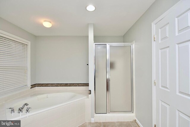 bathroom with tile patterned flooring and plus walk in shower