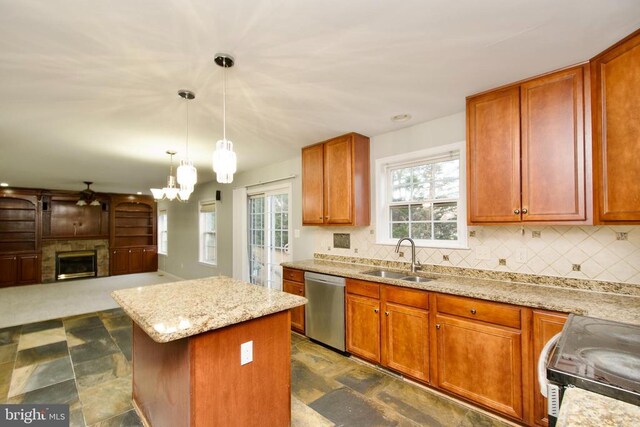 kitchen featuring sink, pendant lighting, a center island, stainless steel dishwasher, and range with electric cooktop