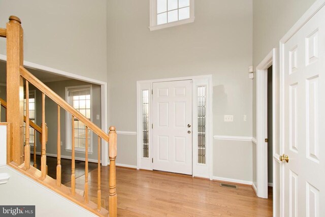 entrance foyer with a high ceiling and light wood-type flooring