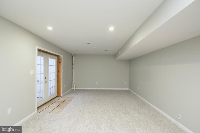 carpeted empty room featuring french doors