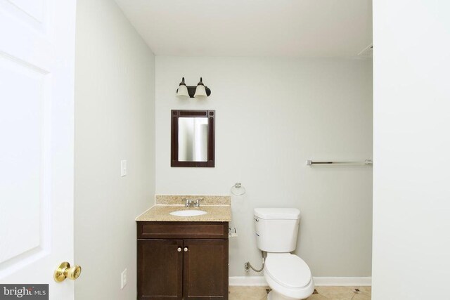 bathroom featuring vanity, toilet, and tile patterned flooring