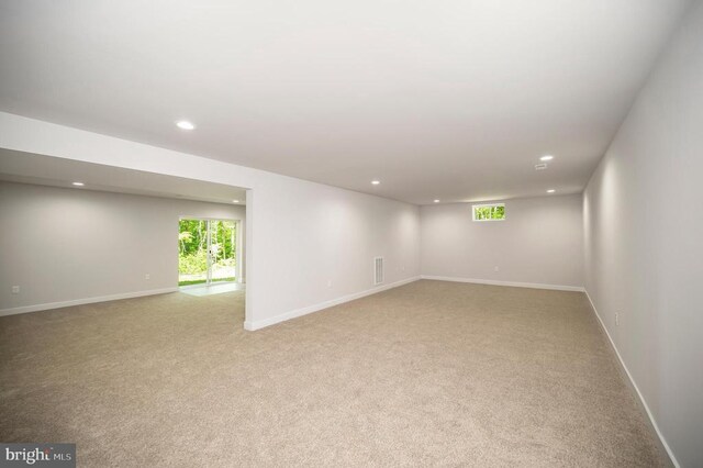 interior space with light carpet and a healthy amount of sunlight