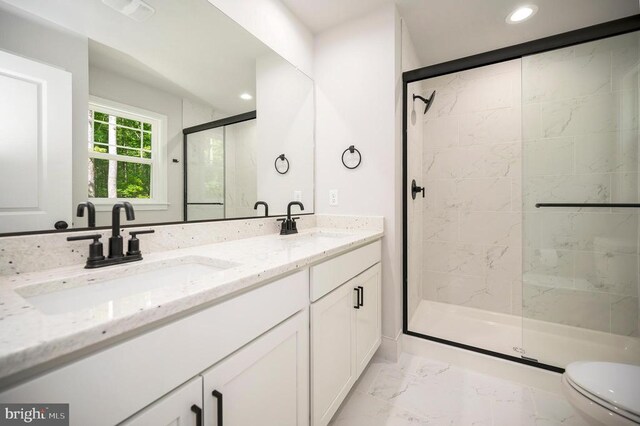 bathroom featuring vanity, toilet, and walk in shower