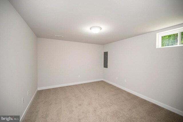 carpeted spare room featuring electric panel