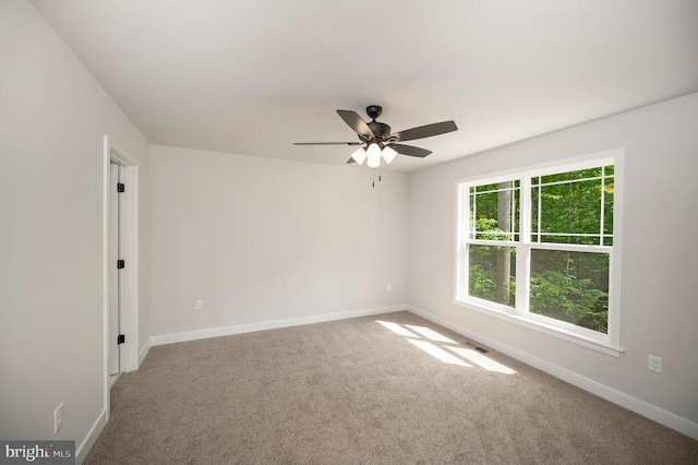 spare room featuring ceiling fan and carpet