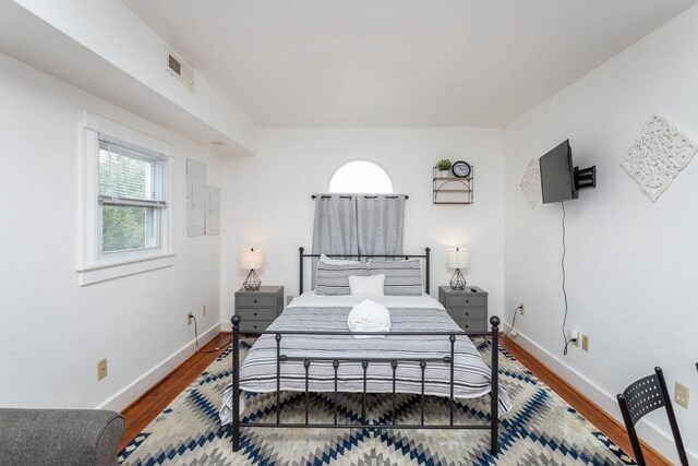 bedroom with hardwood / wood-style floors
