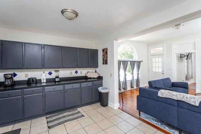 kitchen featuring decorative backsplash and light tile patterned flooring