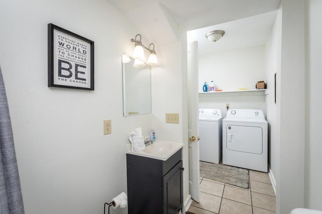 bathroom featuring tile patterned flooring, vanity, and independent washer and dryer