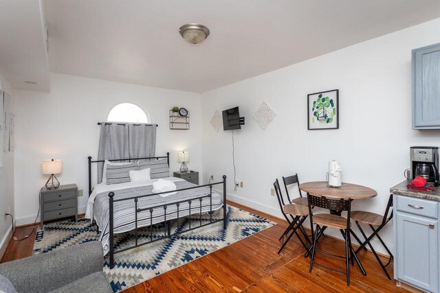 bedroom with wood-type flooring