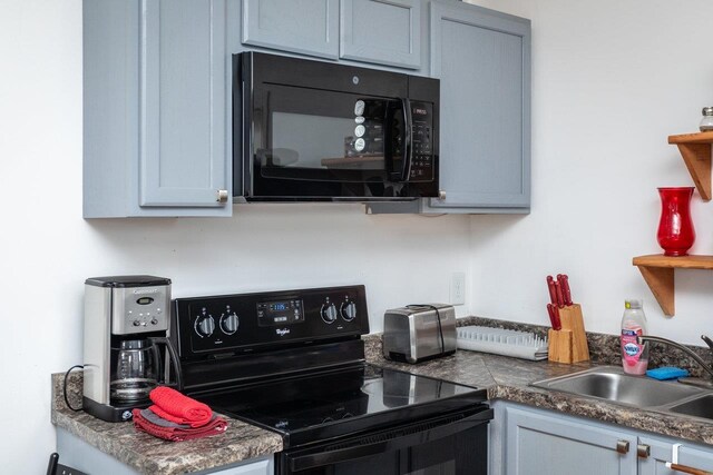 kitchen featuring sink, gray cabinets, and black appliances