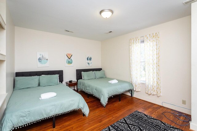 bedroom with hardwood / wood-style flooring