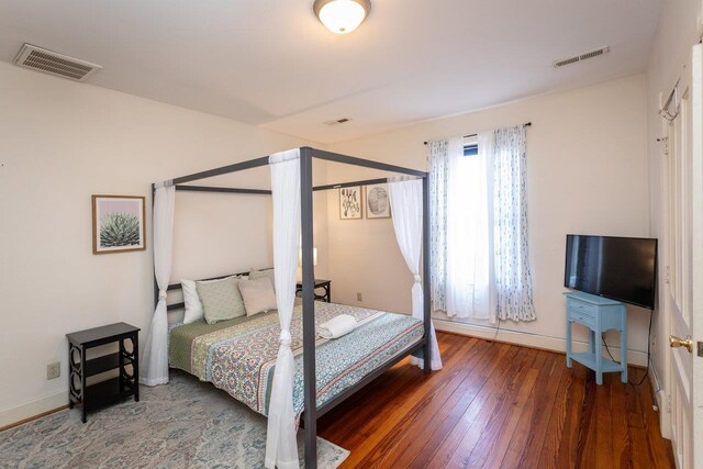 bedroom with dark hardwood / wood-style flooring