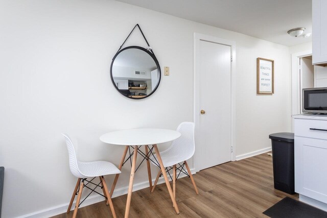 dining area with hardwood / wood-style flooring