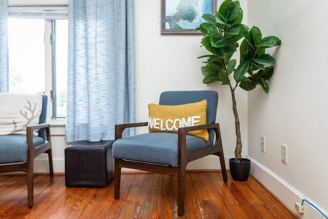 sitting room featuring plenty of natural light and hardwood / wood-style floors