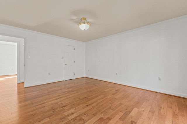 unfurnished room with crown molding, light wood-style floors, and baseboards