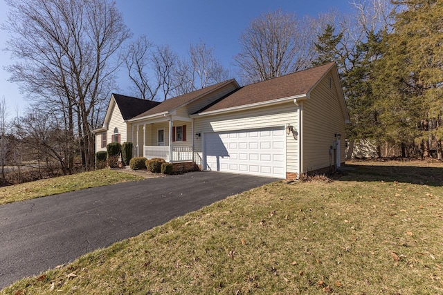 single story home featuring a front yard, covered porch, a garage, and driveway