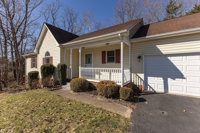 ranch-style house featuring a shingled roof, a porch, a garage, and aphalt driveway