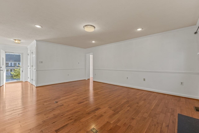 unfurnished room with recessed lighting, baseboards, light wood-type flooring, and ornamental molding