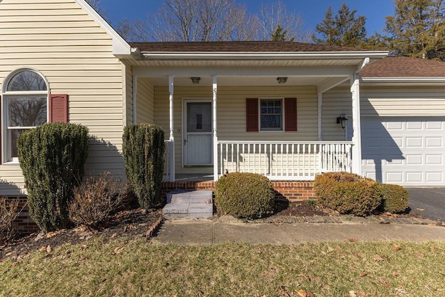 entrance to property with a porch and an attached garage