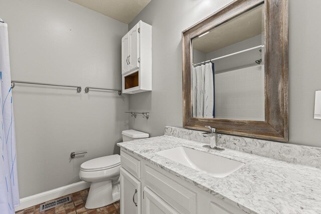 bathroom featuring visible vents, baseboards, toilet, a shower with shower curtain, and vanity