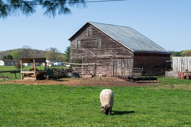 exterior space featuring an outbuilding and a lawn