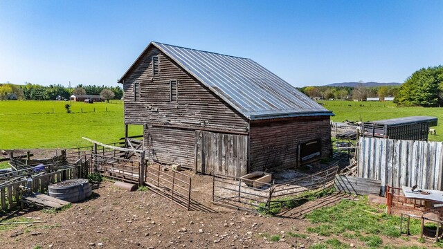 view of outbuilding with a rural view and a mountain view