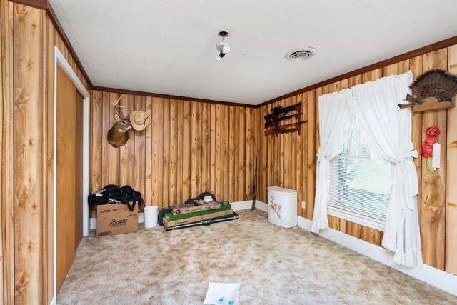 interior space featuring crown molding and wooden walls