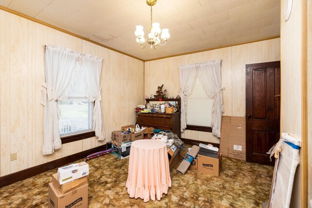 misc room featuring ornamental molding and a chandelier