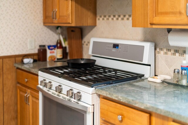 kitchen with white range with gas cooktop