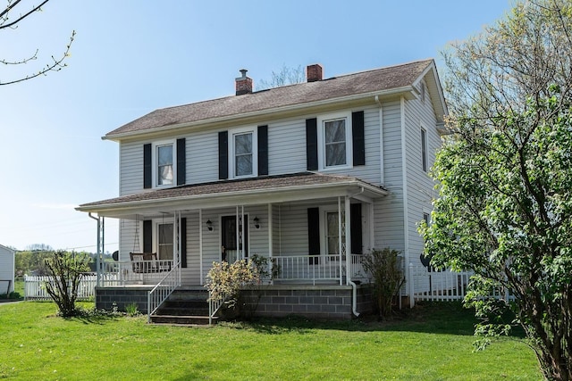 view of front of house featuring a front lawn and covered porch