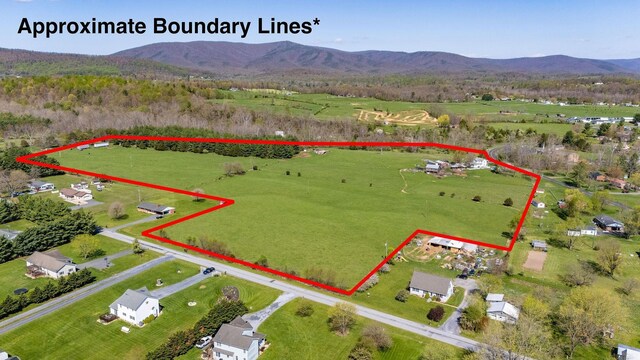 birds eye view of property with a mountain view