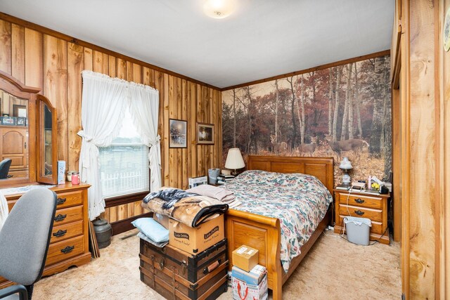 carpeted bedroom featuring ornamental molding and wood walls