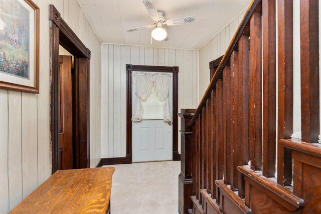 entryway featuring light colored carpet and ceiling fan