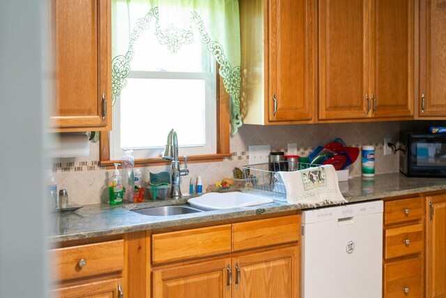 kitchen with dishwasher, sink, and decorative backsplash