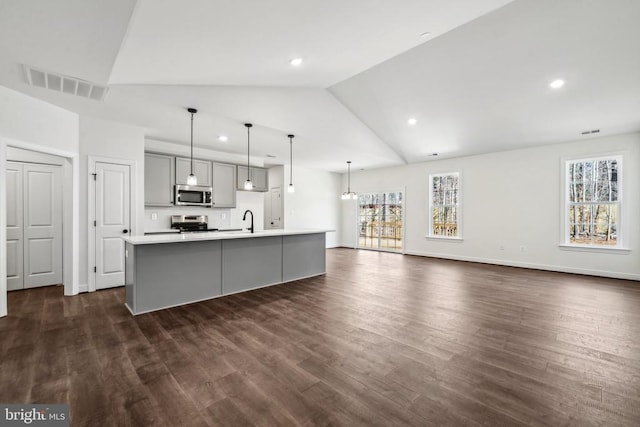 kitchen with gray cabinetry, stainless steel appliances, a sink, visible vents, and light countertops