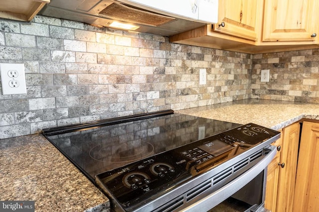 kitchen with tasteful backsplash, premium range hood, electric range, and light brown cabinetry