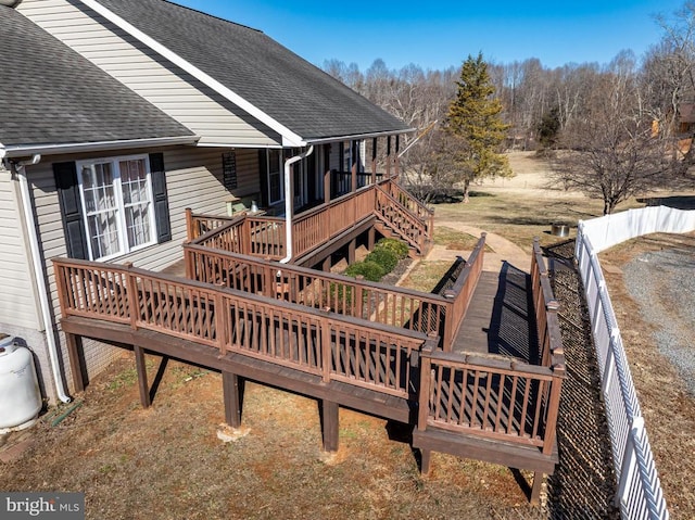 deck with a fenced backyard and stairway