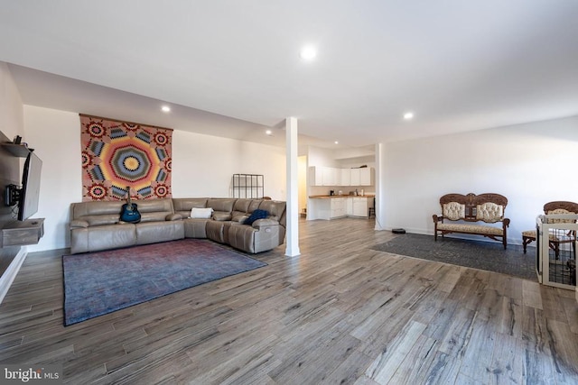 living room with recessed lighting, baseboards, and wood finished floors